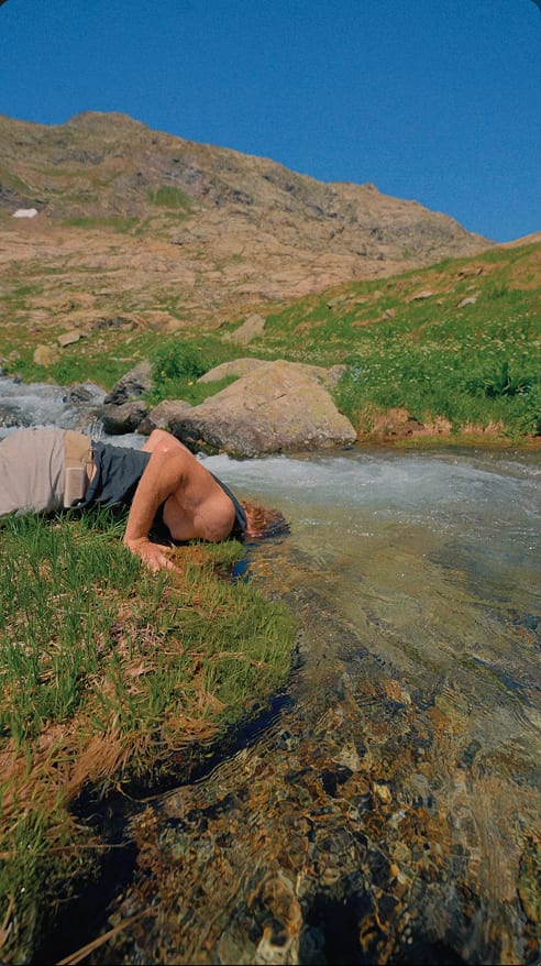 Trail runner crossing alpine terrain in summer — 3CNL Hot Summer Trails series