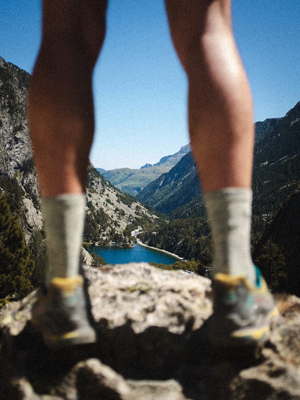 Trail runner's boots resting by a mountain lake — 3CNL Specials series
